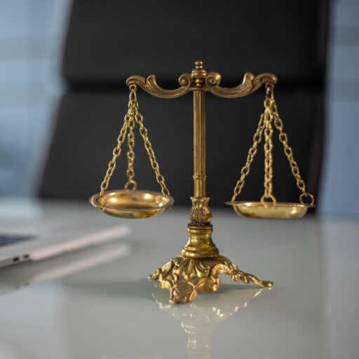 cropped-pexels-photo-6077797.jpeg A Golden Balance Scale beside a Laptop