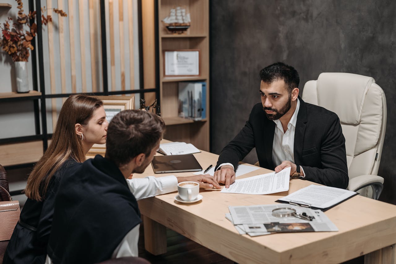 A Man in Black Suit Talking to His Clients